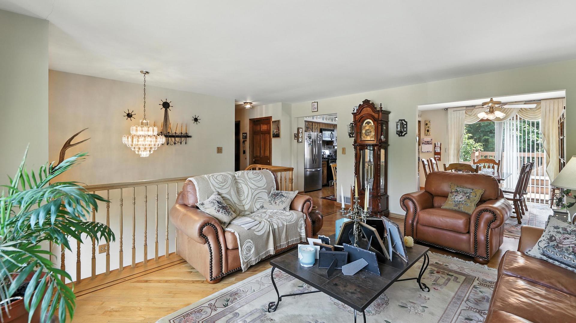 953 Surrey Road Addison, IL 60101 - Photo 3 of 21 a living room with furniture a lamp and a potted plant