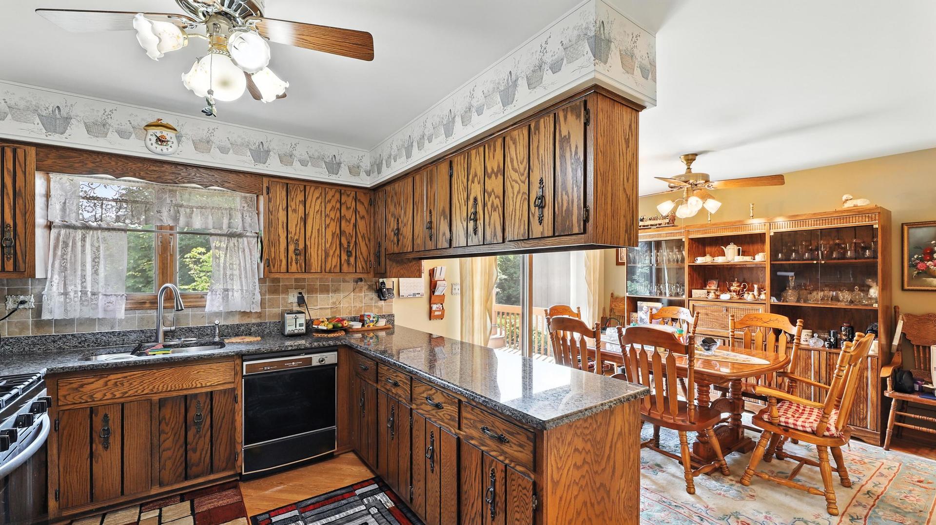 953 Surrey Road Addison, IL 60101 - Photo 5 of 21 a kitchen with stainless steel appliances granite countertop a sink and cabinets