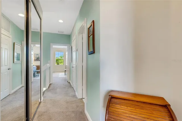 a bedroom with a bed and flat tv screen on the dresser