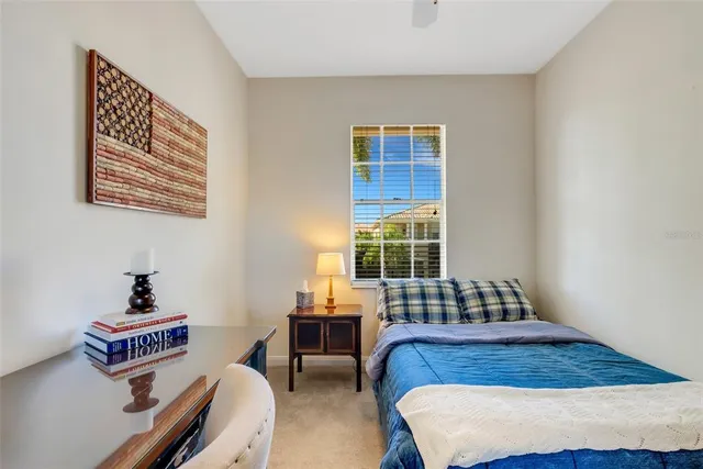 a living room with patio furniture and a floor to ceiling window