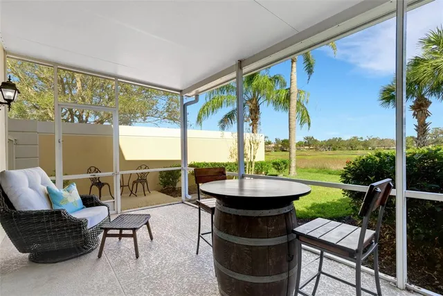 a view of a chair and tables in the balcony