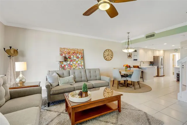 a living room with furniture and a chandelier