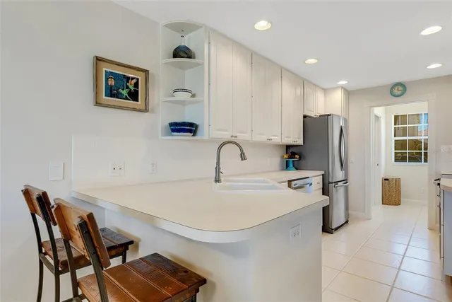 a kitchen with stainless steel appliances a stove a sink cabinets and a counter top space