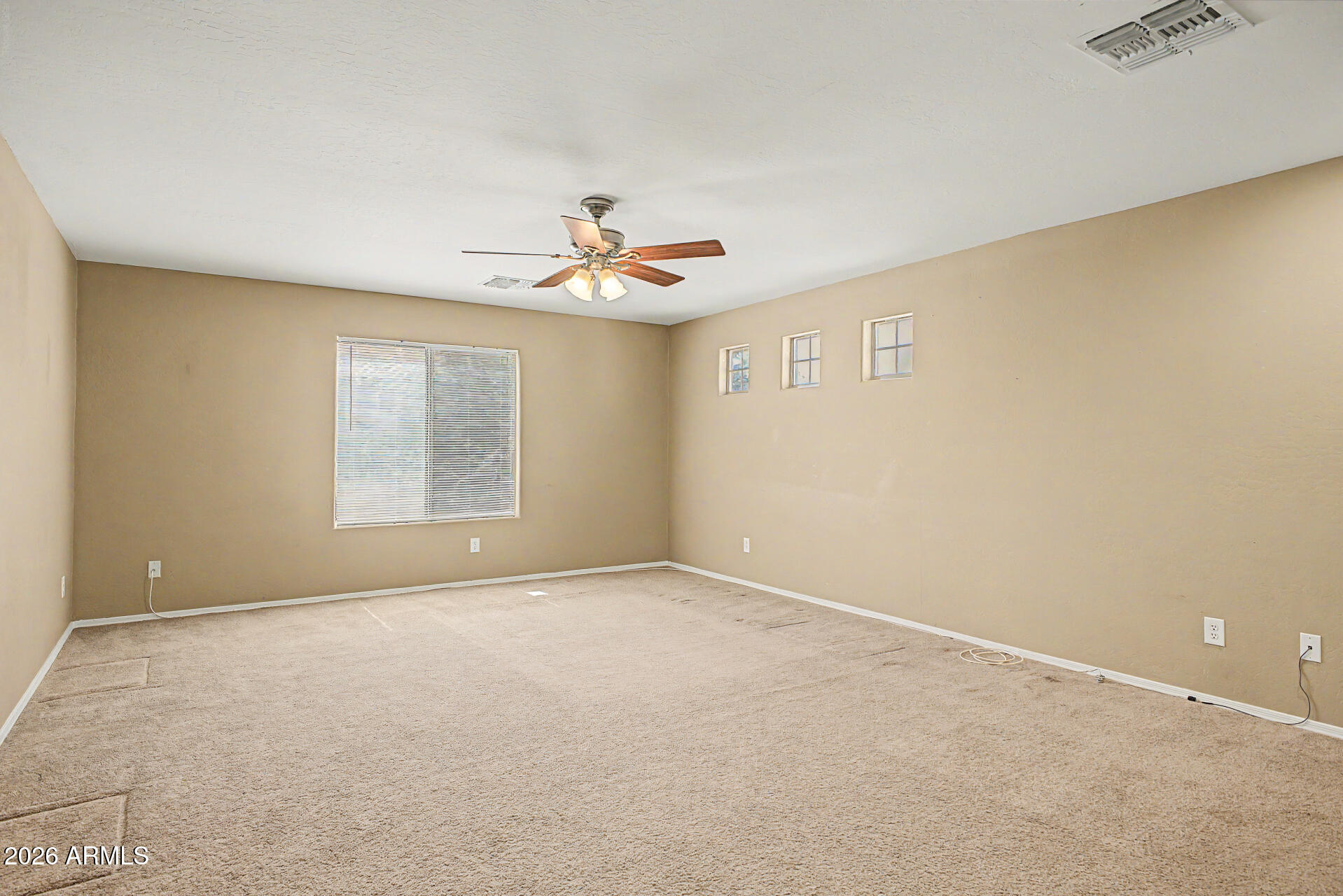 6622 West Harwell Road Laveen, AZ 85339 - Photo 14 of 32 an empty room with windows and ceiling fan