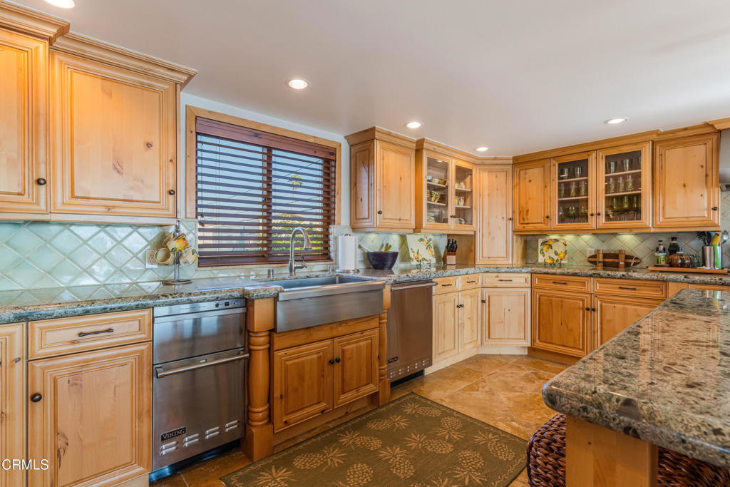 268 Sunset Drive Oxnard, CA 93035 - Photo 8 of 32 a kitchen with stainless steel appliances granite countertop a stove a sink and a refrigerator