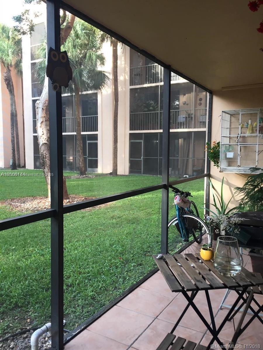 8420 Southwest 133rd Avenue Road, Unit 213 Miami, FL 33183 - Photo 16 of 16 a view of a backyard with sitting area and garden