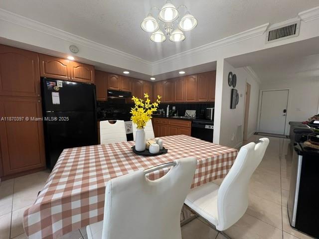 8420 Southwest 133rd Avenue Road, Unit 213 Miami, FL 33183 - Photo 5 of 16 a kitchen with a table chairs and refrigerator