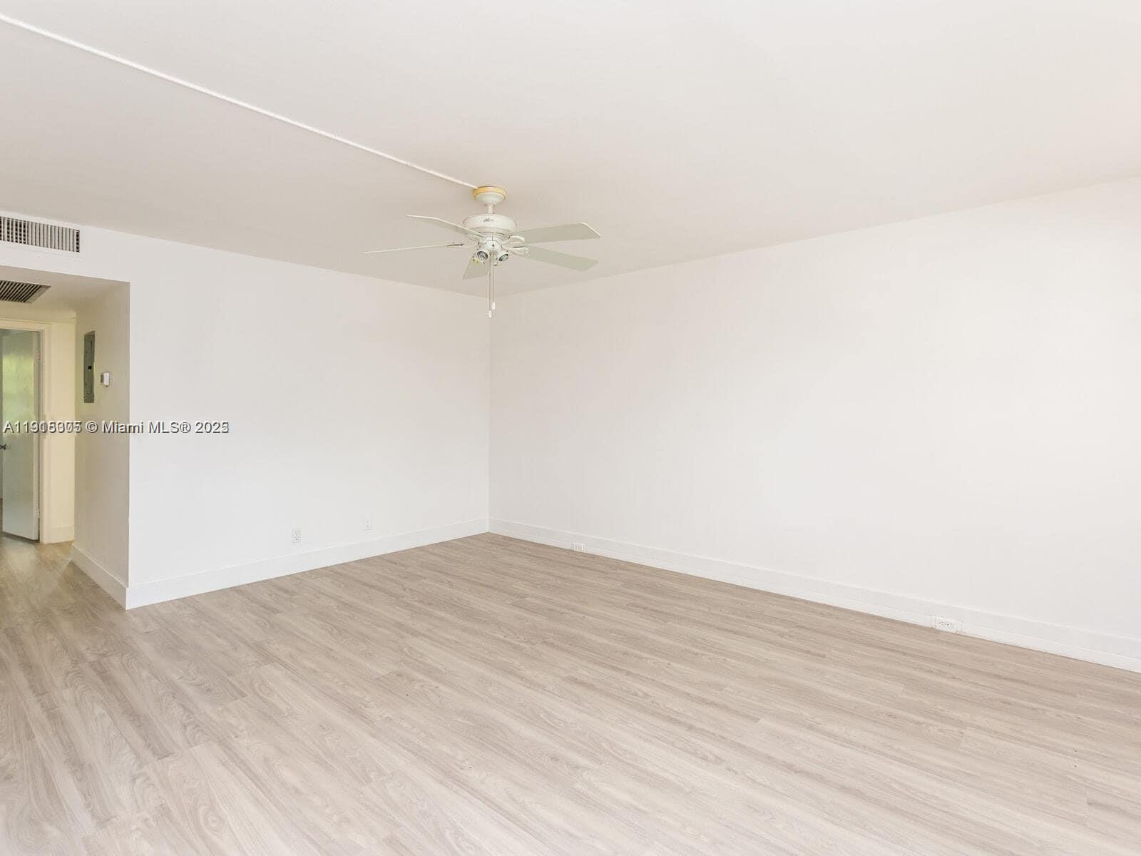 850 Southwest 133rd Terrace, Unit 206B Pembroke Pines, FL 33027 - Photo 7 of 9 a view of empty room with wooden floor