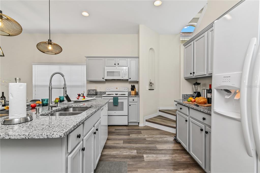 16640 Palm Spring Drive Clermont, FL 34714 - Photo 14 of 79 a kitchen with stainless steel appliances granite countertop a refrigerator a stove and a sink