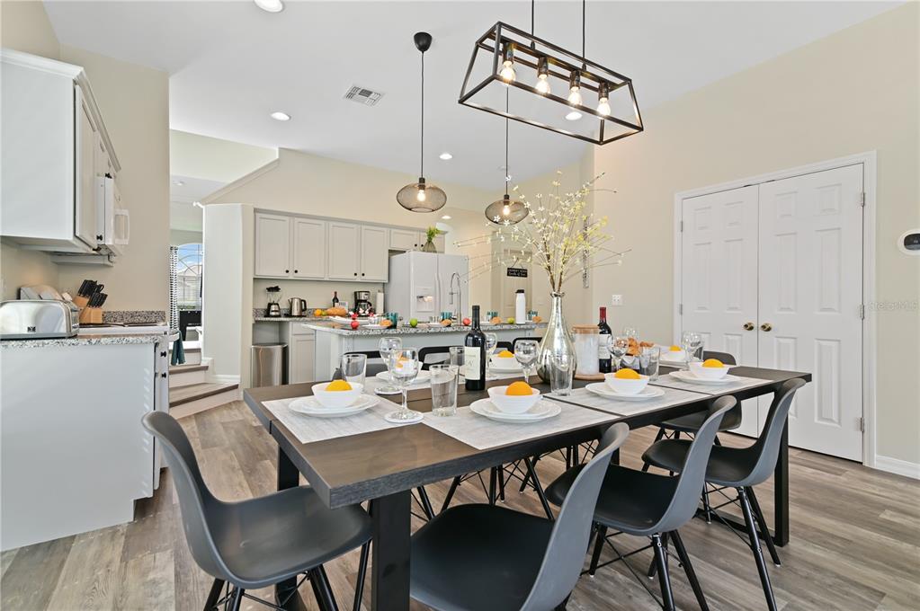 16640 Palm Spring Drive Clermont, FL 34714 - Photo 21 of 79 a view of a dining room and livingroom with furniture wooden floor kitchen view and a chandelier