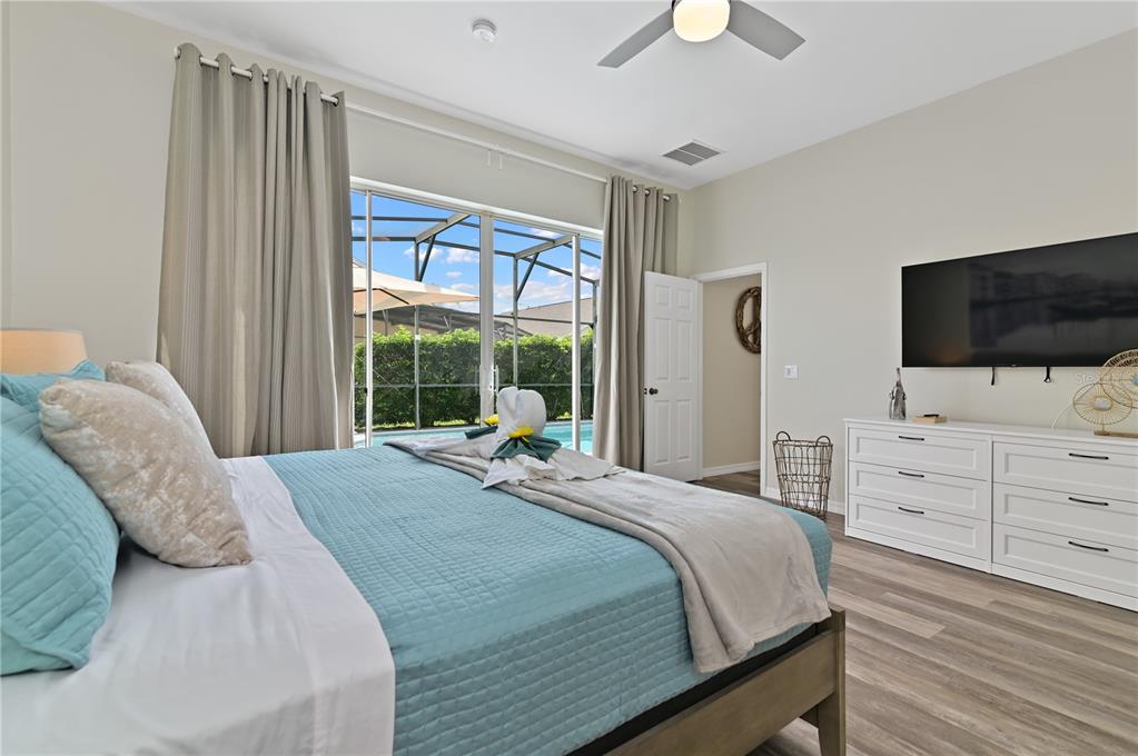 16640 Palm Spring Drive Clermont, FL 34714 - Photo 32 of 79 a bedroom with a large bed and a flat screen tv