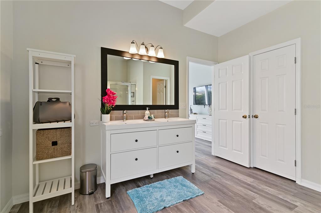 16640 Palm Spring Drive Clermont, FL 34714 - Photo 35 of 79 a bathroom with a double vanity sink and a mirror