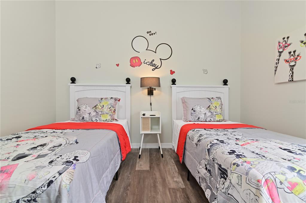 16640 Palm Spring Drive Clermont, FL 34714 - Photo 39 of 79 a bedroom with two beds and a chandelier