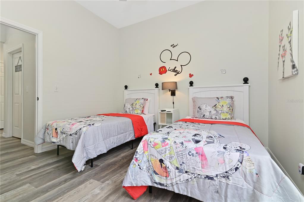 16640 Palm Spring Drive Clermont, FL 34714 - Photo 40 of 79 a bedroom with two beds and a baby crib