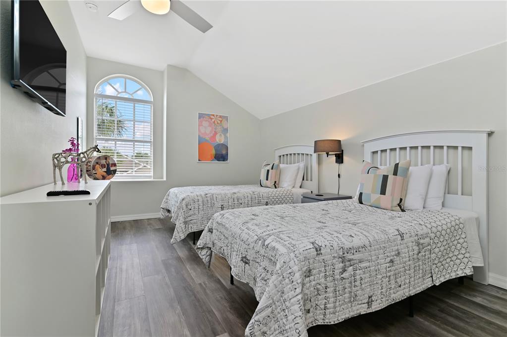 16640 Palm Spring Drive Clermont, FL 34714 - Photo 58 of 79 a bedroom with a bed a dresser and flat screen tv