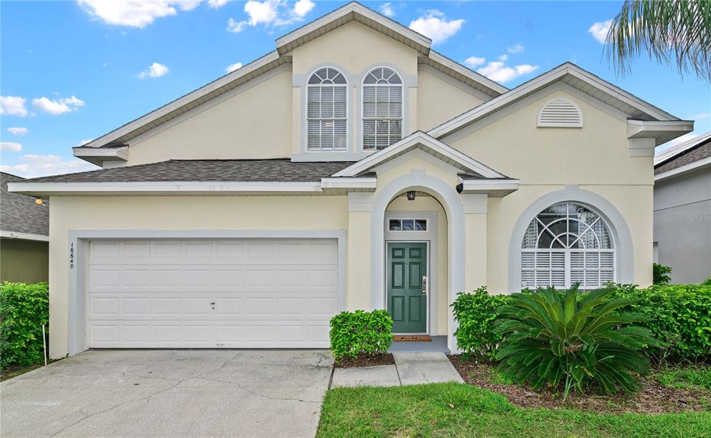 16640 Palm Spring Drive Clermont, FL 34714 - Photo 8 of 79 a front view of a house with garden