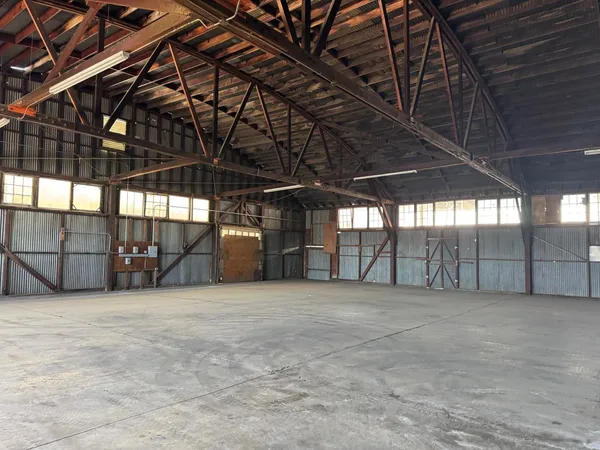 a view of an empty room with wooden walls