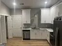 a kitchen with stainless steel appliances granite countertop a sink and a refrigerator