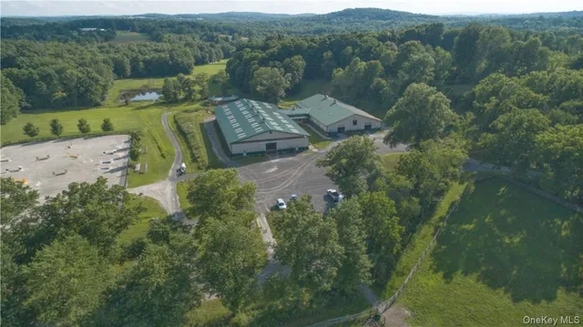 an aerial view of a house with a yard and lake view