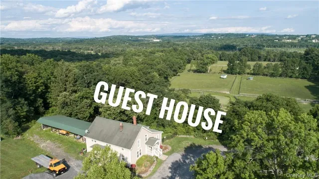 a kitchen with stainless steel appliances granite countertop a table chairs and a refrigerator