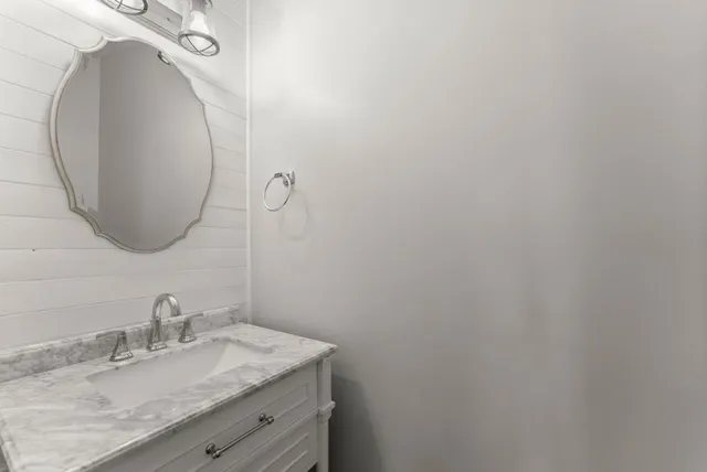 an empty room with windows and chandelier fan