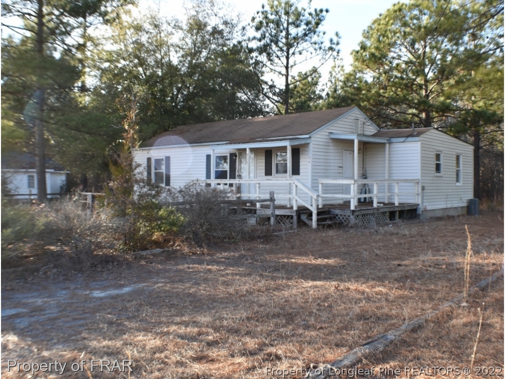 216 Sands Road Carthage, NC 28327 - Photo 1 of 28 a front view of a house with a yard and trees