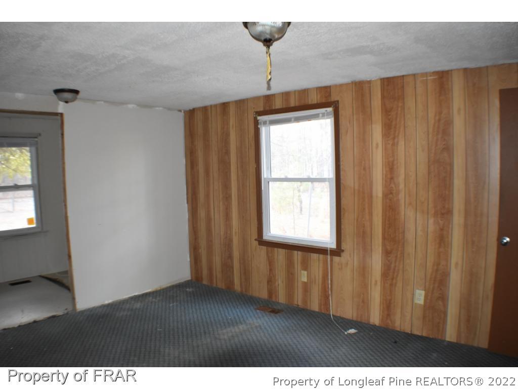 216 Sands Road Carthage, NC 28327 - Photo 17 of 28 a view of an empty room with a window