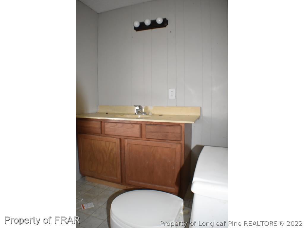 216 Sands Road Carthage, NC 28327 - Photo 20 of 28 a bathroom with a toilet a sink and mirror