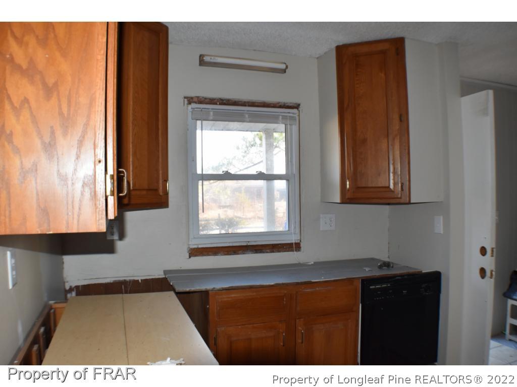 216 Sands Road Carthage, NC 28327 - Photo 6 of 28 a kitchen view with wooden floor and window