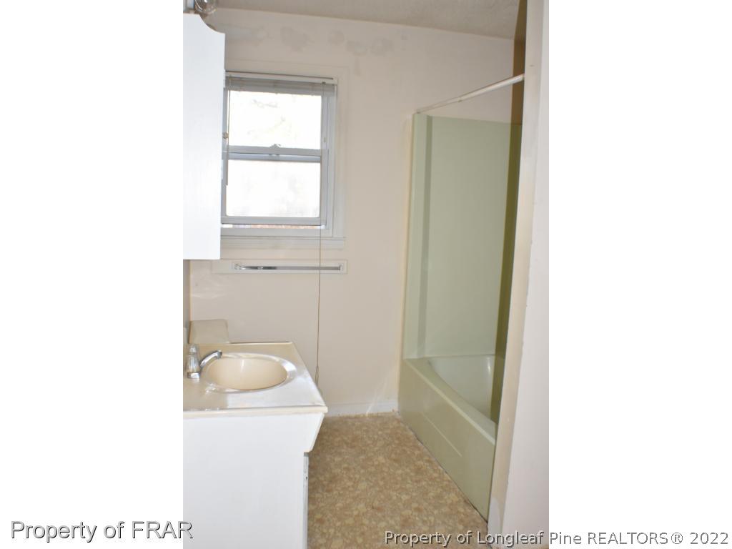 216 Sands Road Carthage, NC 28327 - Photo 9 of 28 a bathroom with a toilet a sink and mirror