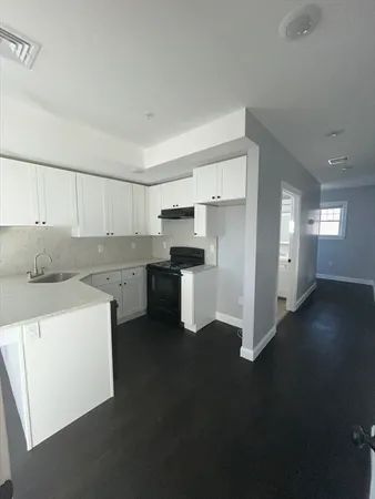 a kitchen with a sink and a refrigerator