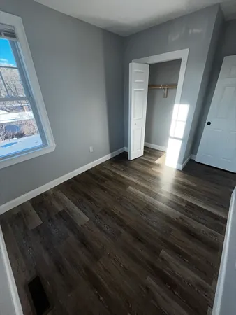 a view of an empty room and wooden floor