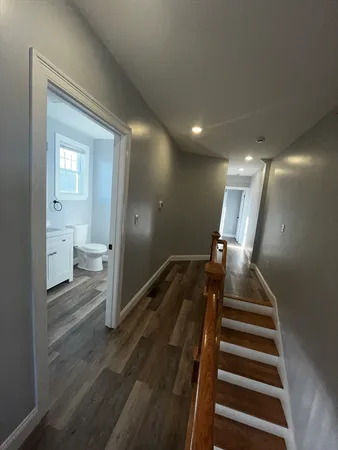 a view of entryway and hall with wooden floor