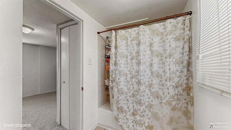 2140 Indianapolis Boulevard Whiting, IN 46394 - Photo 27 of 63 a bathroom with a shower curtain and a curtain