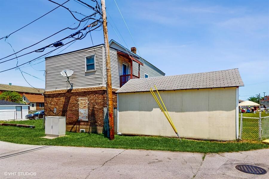 2140 Indianapolis Boulevard Whiting, IN 46394 - Photo 33 of 63 a front view of a house with a yard and garage