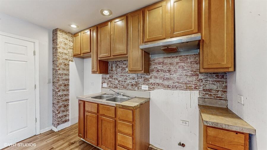 2140 Indianapolis Boulevard Whiting, IN 46394 - Photo 43 of 63 a kitchen with stainless steel appliances granite countertop a sink stove and cabinets