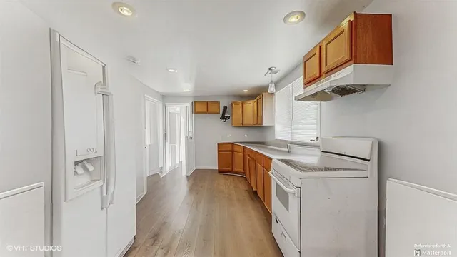 a kitchen with stainless steel appliances granite countertop a sink and cabinets