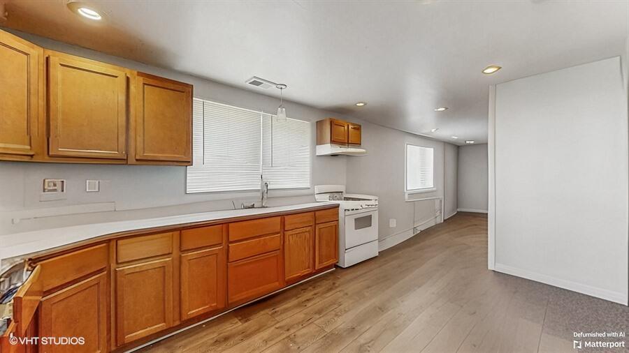 2140 Indianapolis Boulevard Whiting, IN 46394 - Photo 8 of 63 a large kitchen with stainless steel appliances granite countertop a sink and cabinets with wooden floor