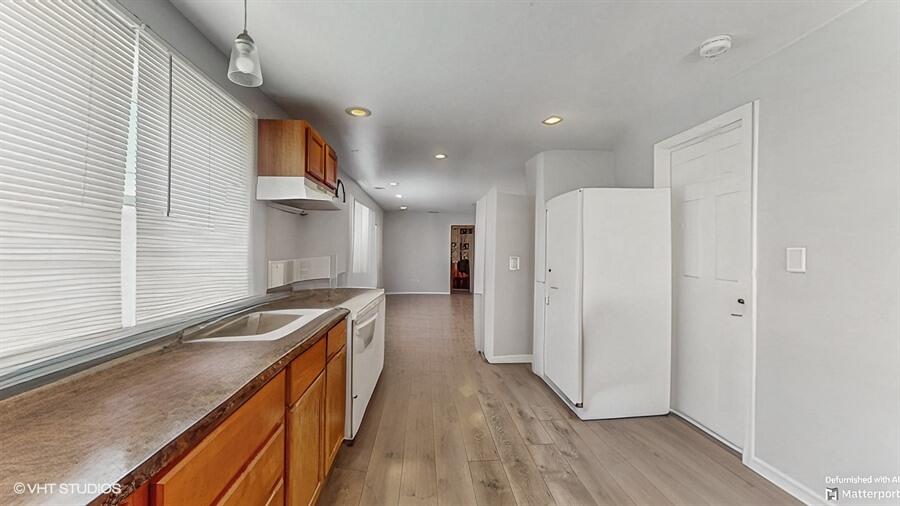 2140 Indianapolis Boulevard Whiting, IN 46394 - Photo 9 of 63 a kitchen with stainless steel appliances granite countertop a sink a stove and a refrigerator