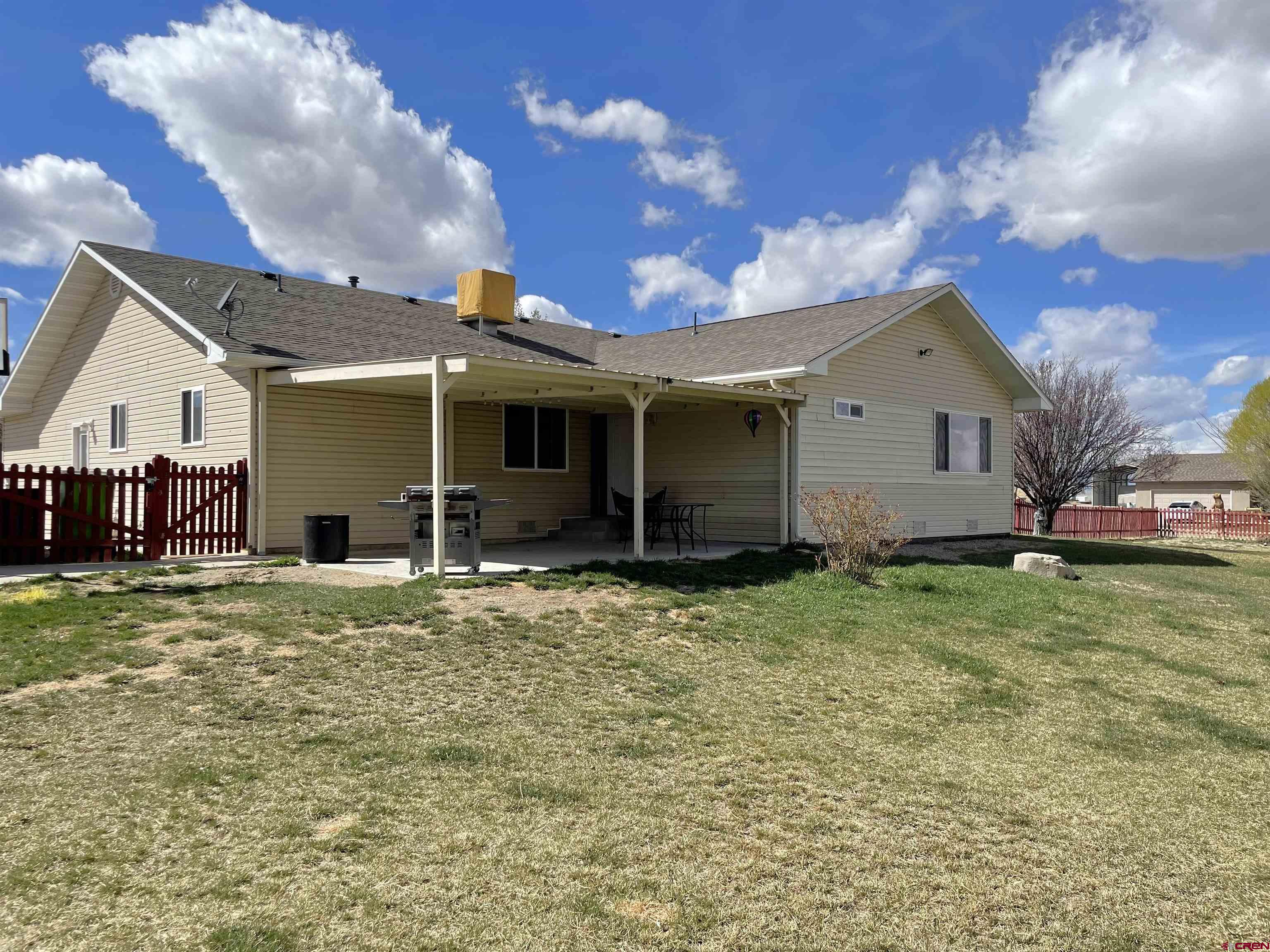8902 6085 Road Montrose, CO 81401 - Photo 19 of 31 a view of a house with a backyard