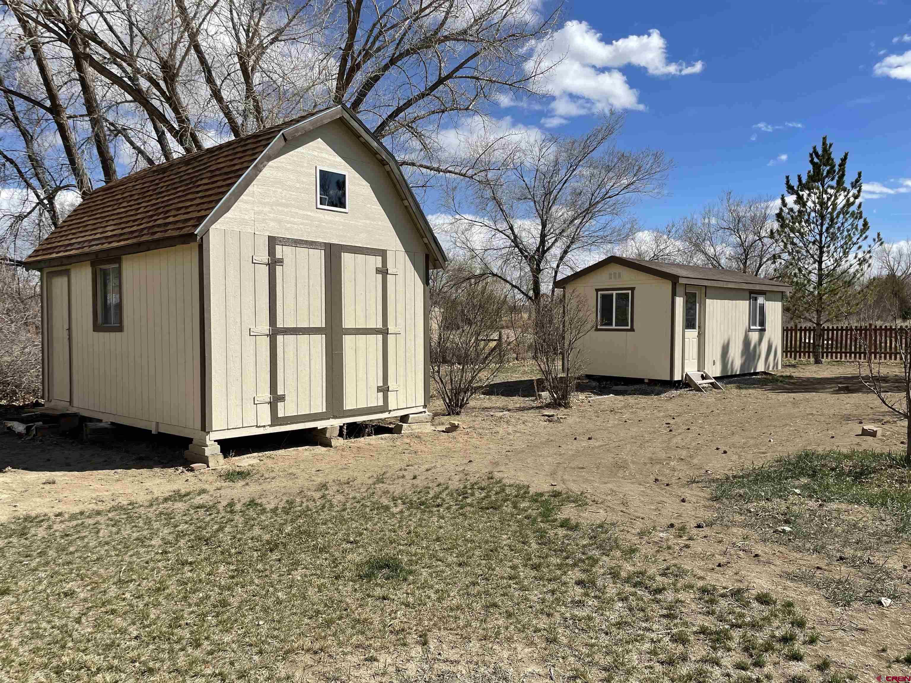 8902 6085 Road Montrose, CO 81401 - Photo 21 of 31 a view of a white house with a yard