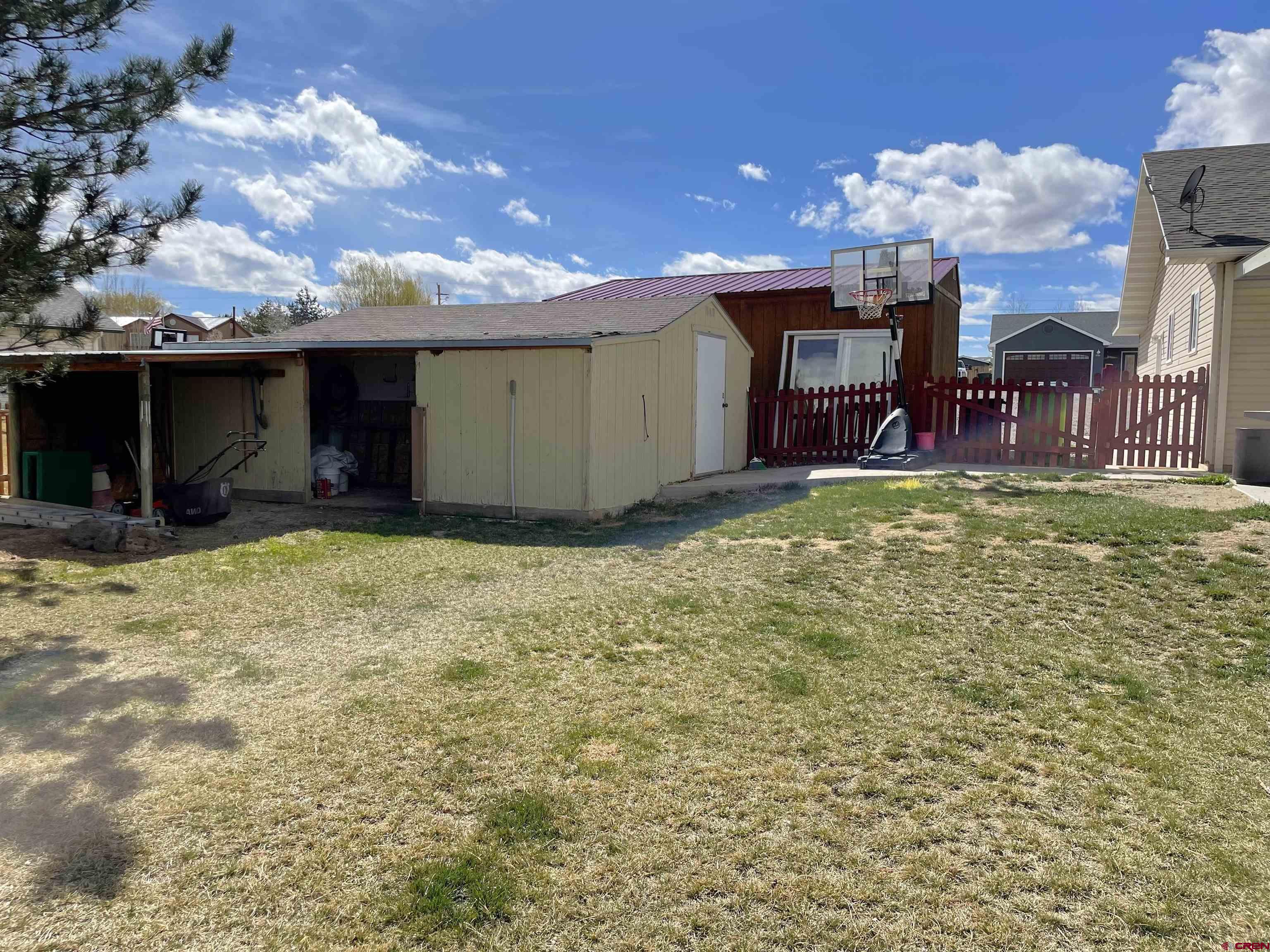 8902 6085 Road Montrose, CO 81401 - Photo 24 of 31 a view of a house with a yard