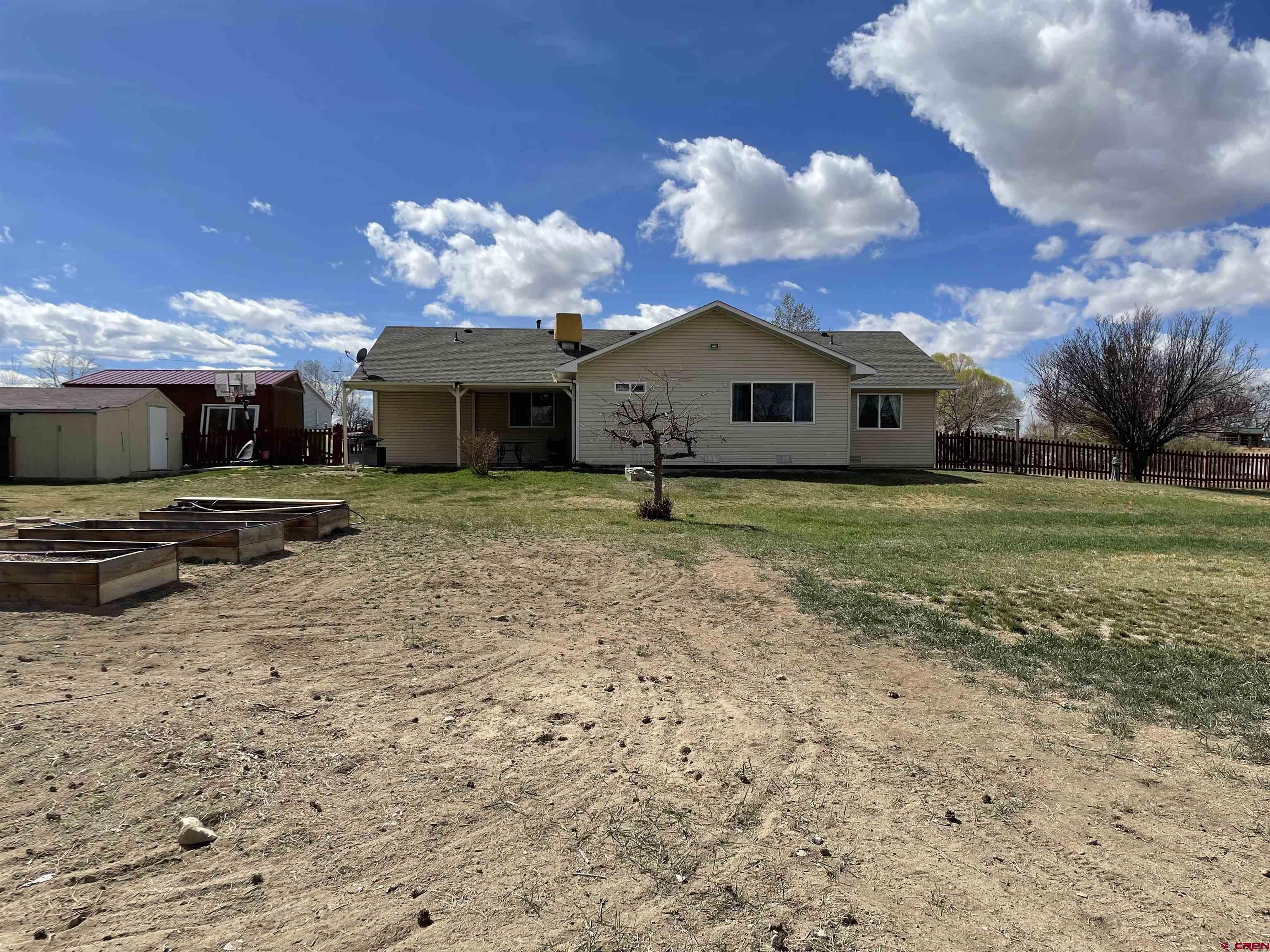 8902 6085 Road Montrose, CO 81401 - Photo 25 of 31 a view of a house with a yard