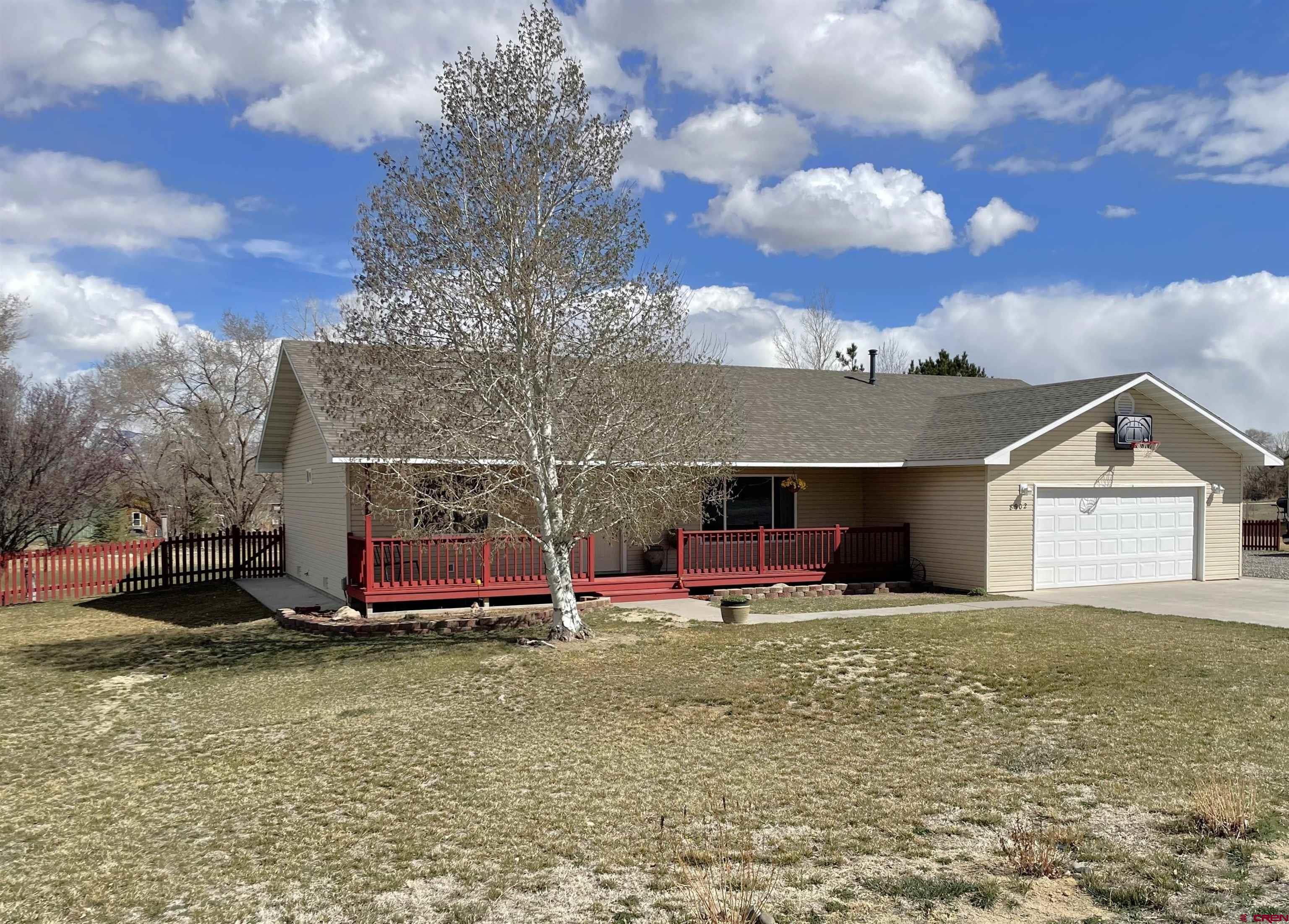 8902 6085 Road Montrose, CO 81401 - Photo 26 of 31 a view of a house with backyard and porch