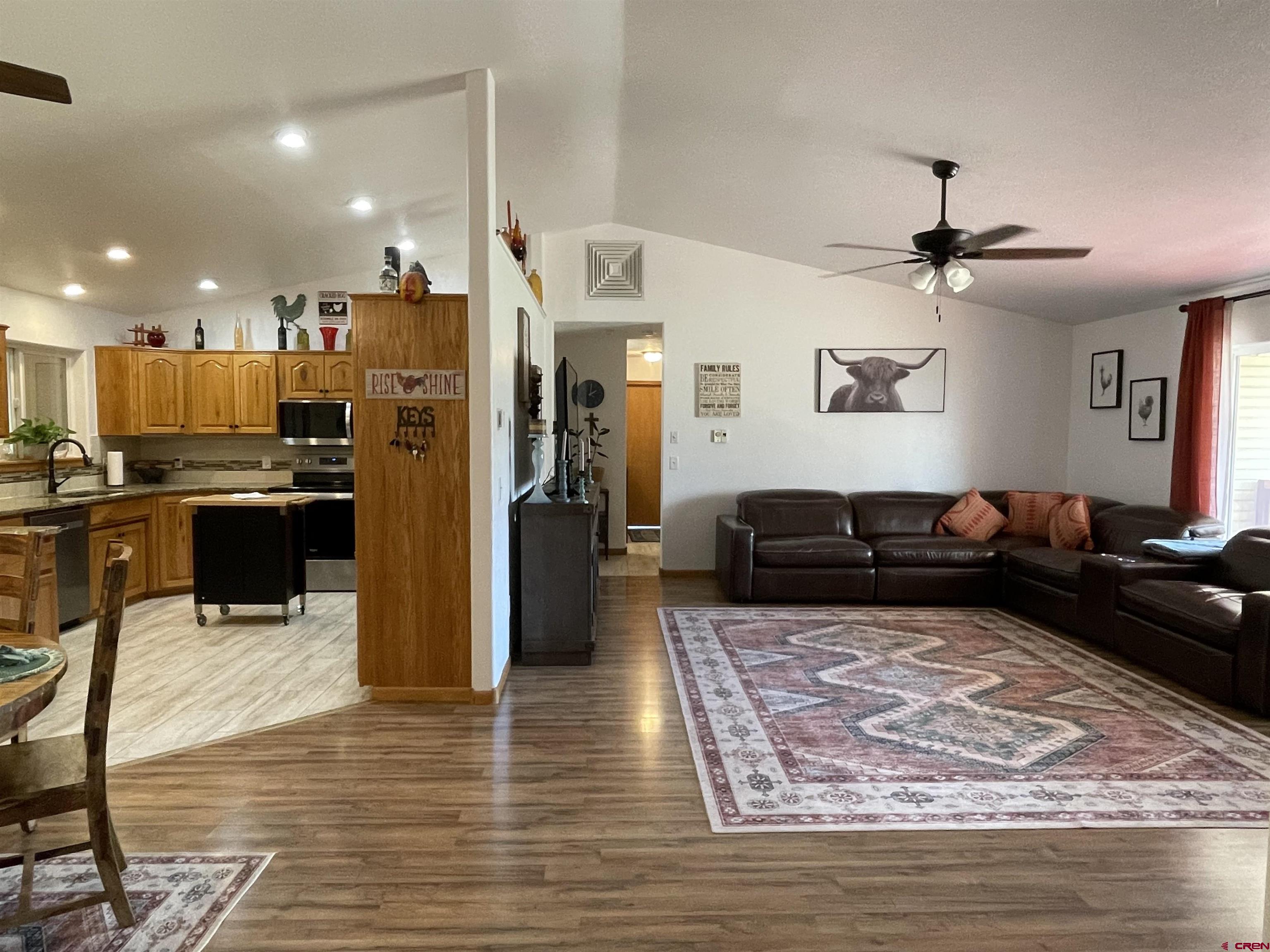 8902 6085 Road Montrose, CO 81401 - Photo 4 of 31 a living room with stainless steel appliances furniture or couch and a view of kitchen