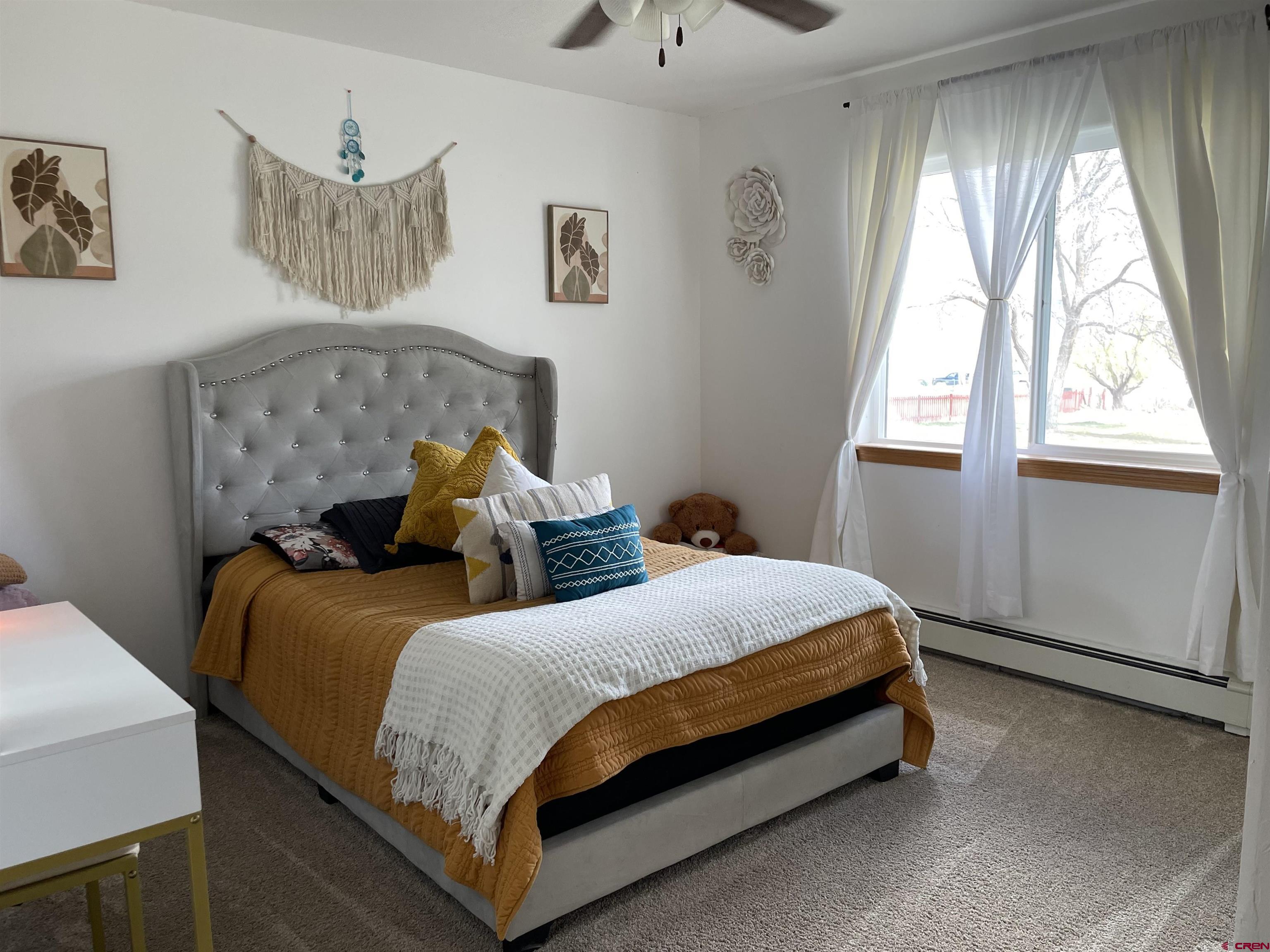 8902 6085 Road Montrose, CO 81401 - Photo 8 of 31 a bedroom with a bed and window