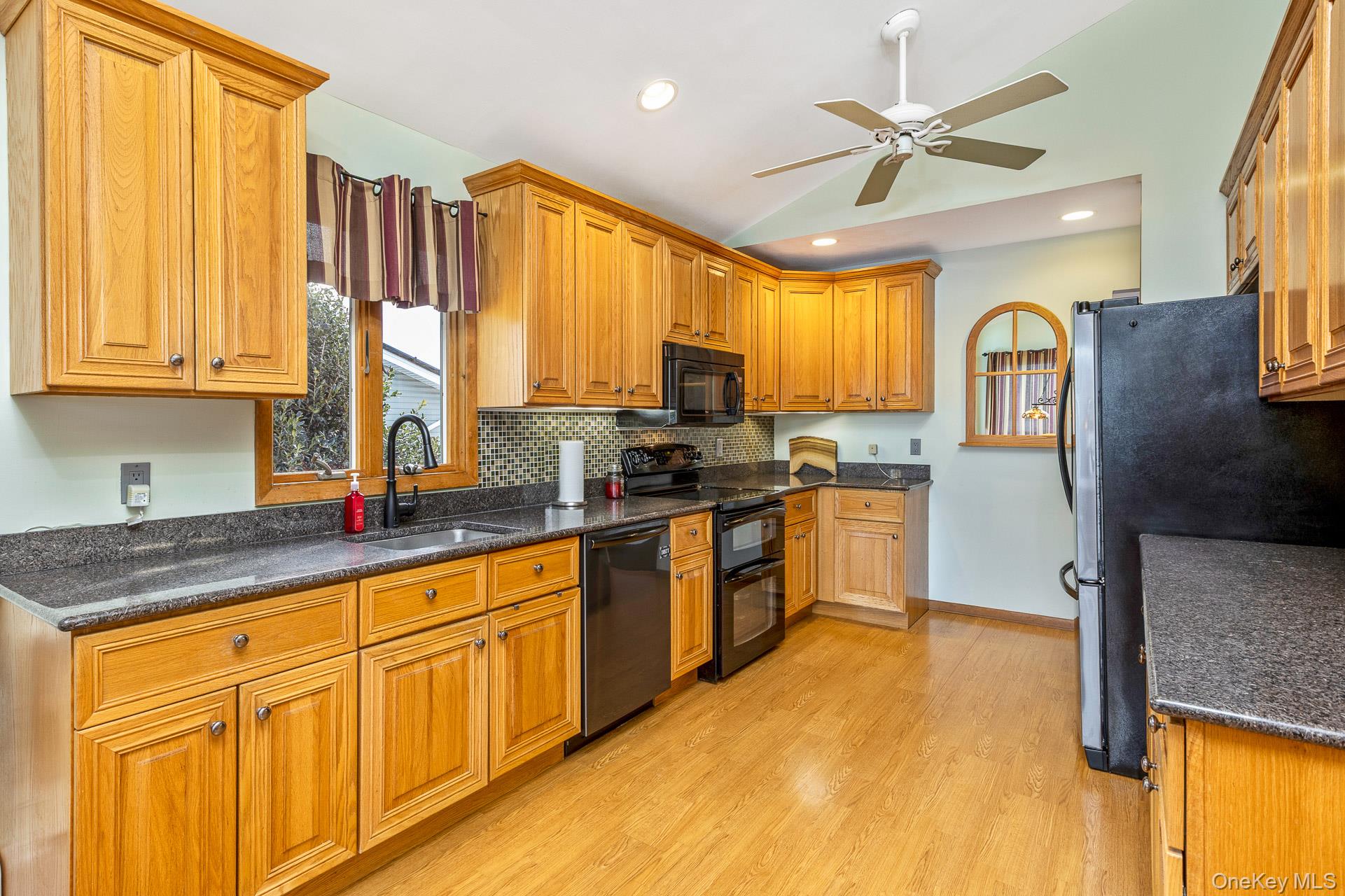173 Fifty Acre Road South Smithtown, NY 11787 - Photo 16 of 42 a kitchen with stainless steel appliances granite countertop a stove a sink and a refrigerator