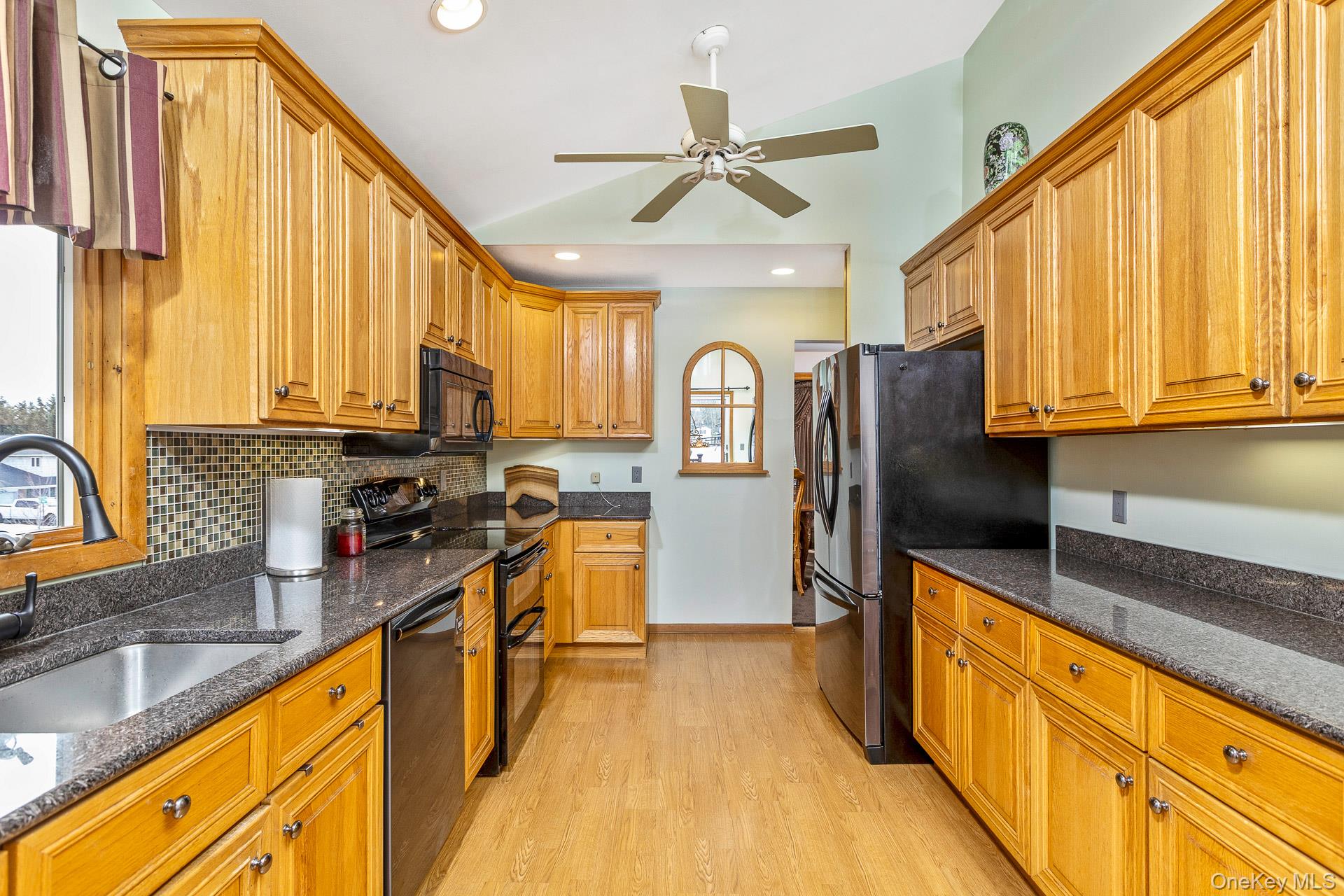 173 Fifty Acre Road South Smithtown, NY 11787 - Photo 17 of 42 a view of a kitchen with kitchen island granite countertop a large window a sink appliances and cabinets