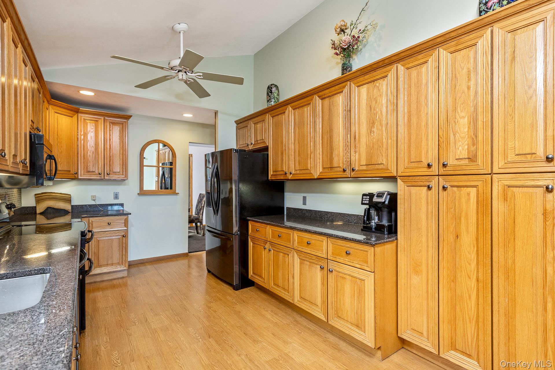 173 Fifty Acre Road South Smithtown, NY 11787 - Photo 18 of 42 a kitchen with stainless steel appliances a refrigerator sink and cabinets