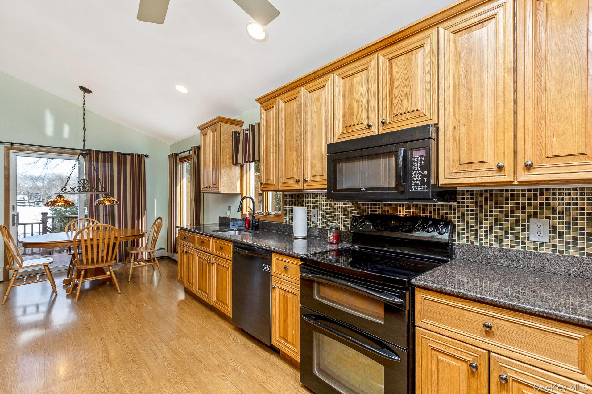 173 Fifty Acre Road South Smithtown, NY 11787 - Photo 20 of 42 a kitchen with stainless steel appliances a stove sink microwave and cabinets